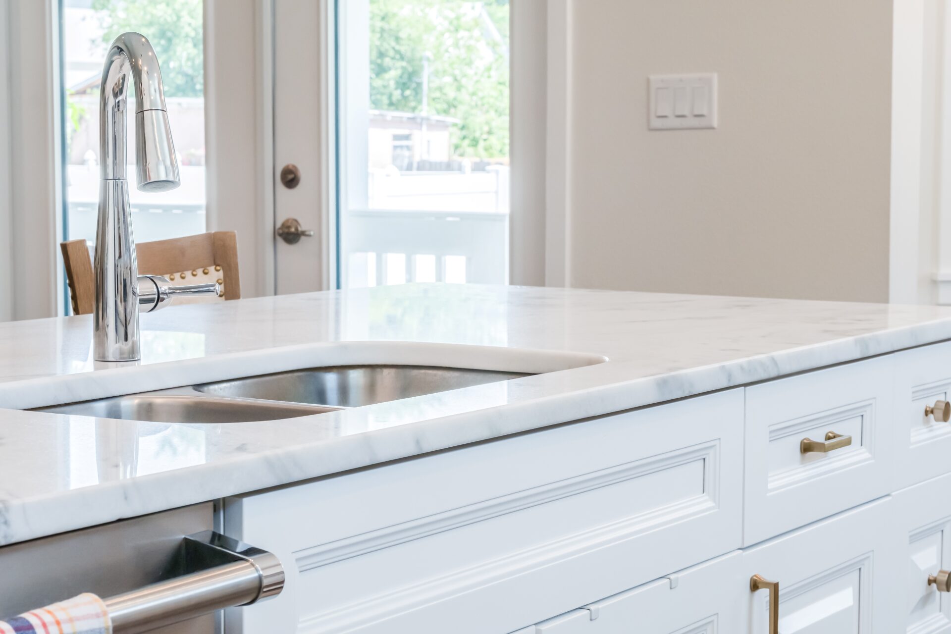 A dish washing sink with white theme